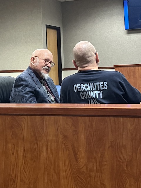 Rusty Pugh, sentenced to nearly 232 years in prison Thursday, listens to lawyer Michael Curtis in Deschutes County Circuit Court. The Bulletin/Noemi Arellano-Summer.